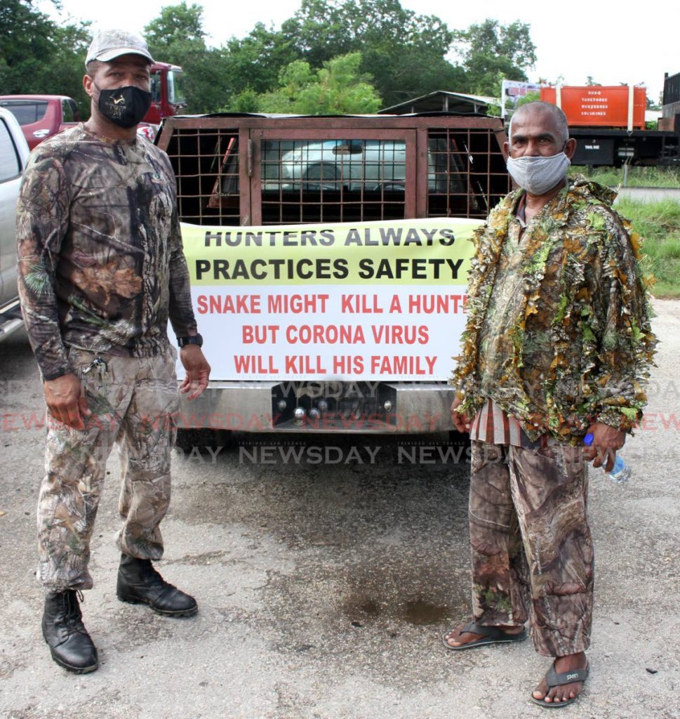 File photo of Top Gunz Hunting Association Vice President Keith Steele and East Hunting Association member Doodnath Singh, stand by and empty dog cage on a pick-up truck, at the Caroni Bird Sanctuary car park on Wednesday morning. Hunters are protesting the supension of hunting season. - Angelo Marcelle