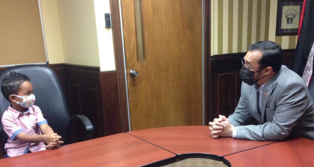 LET'S CHAT: Six-year-old Zane meets with National Security Minister Stuart Young on Monday at the minister's Port of Spain office. PHOTO COURTESY MINISTRY OF NATIONAL SECURITY - Nat Sec Min