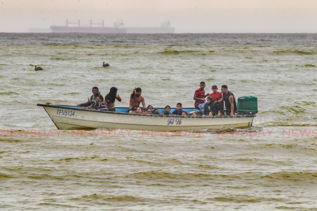 Venezuelans including 16 children onboard a pirogue made its way to Los Iros beach after a high court judge ordered the authorities to produce them followinga deportation order. - Lincoln Holder