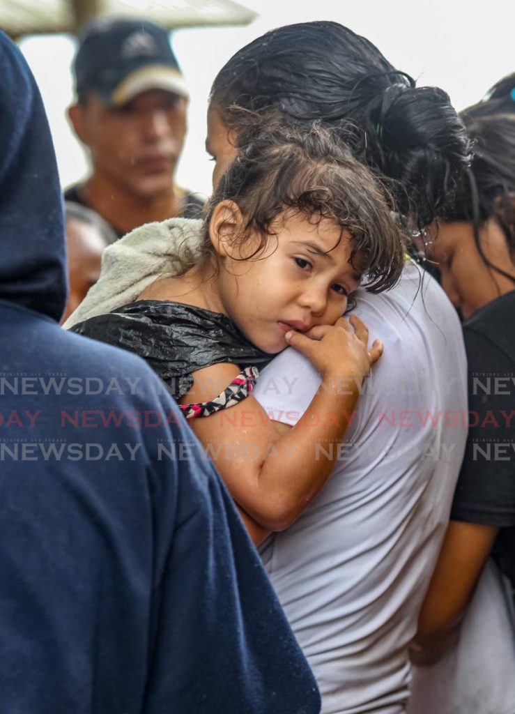 A group of Venezuelans, including 16 children, came ashore by boat at a Los Iros beach shortly before 1 pm on Tuesday. - Lincoln Holder