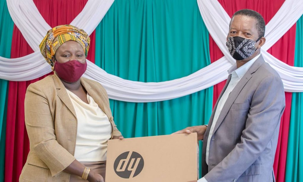Schools Supervisor III, Division of Education Sherry Ann Rollocks-Hackett, left, receives a laptop donated by a representative from the Eco-Industrial Development Company of Tobago on Monday. PHOTO COURTESY THA - 