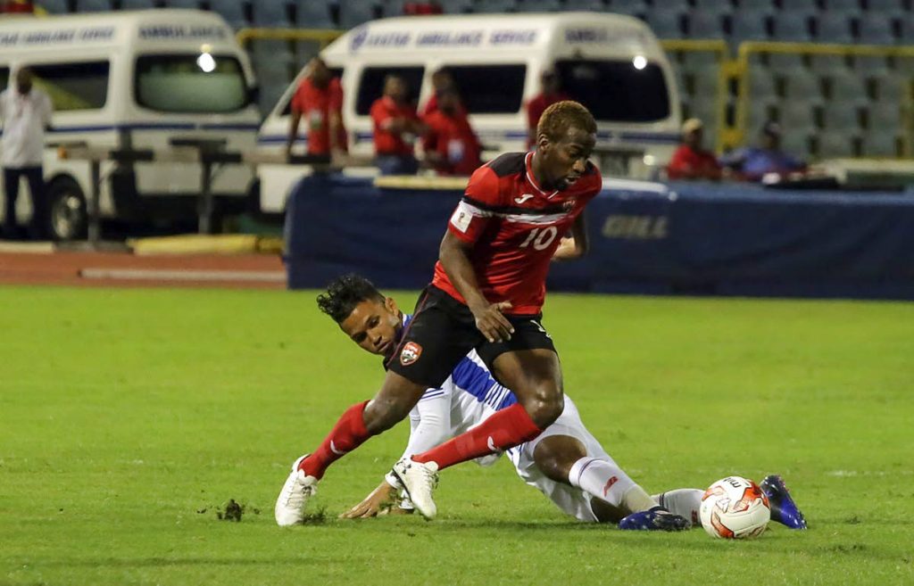 In this March 24, 2017 file photo, TT midfielder Kevin Molino tries to control the ball past Panama’s midfielder Amilcar Henriquez during their 2018 FIFA World Cup qualifier match, at the Hasely Crawford Stadium, Port of Spain. - (AFP PHOTO)