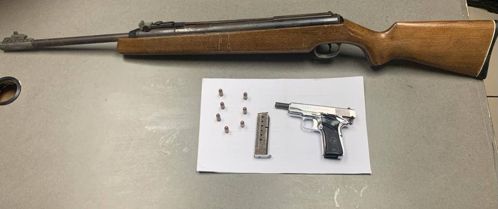 An air rifle and a pistol with seven rounds of ammunition seized at a house in Mahelal Street, Aranguez, on Thursday night. 
Police said two men, a father and son were arrested in connection with the find. 

PHOTO COURTESY TTPS - TTPS