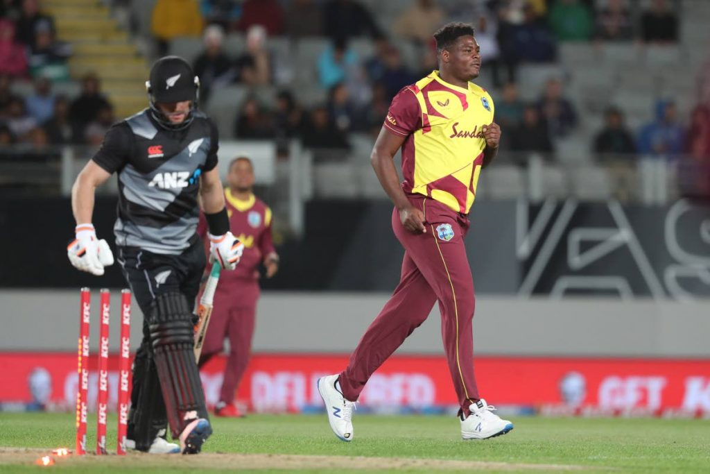 West Indies' fast bowler Oshane Thomas (rigt) celebrates taking the wicket of New Zealand’s Glenn Phillips (left) during the teams' T20 International at Eden Park in Auckland on Friday. (AFP PHOTO) - 