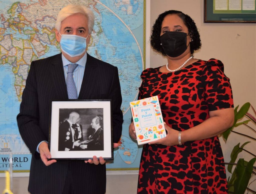 Lisa Morris-Julian, Minister in the Ministry of Education, holds a copy of  Prosa y Poesa. At left is Chilean Ambassador Juan Anibal. - 