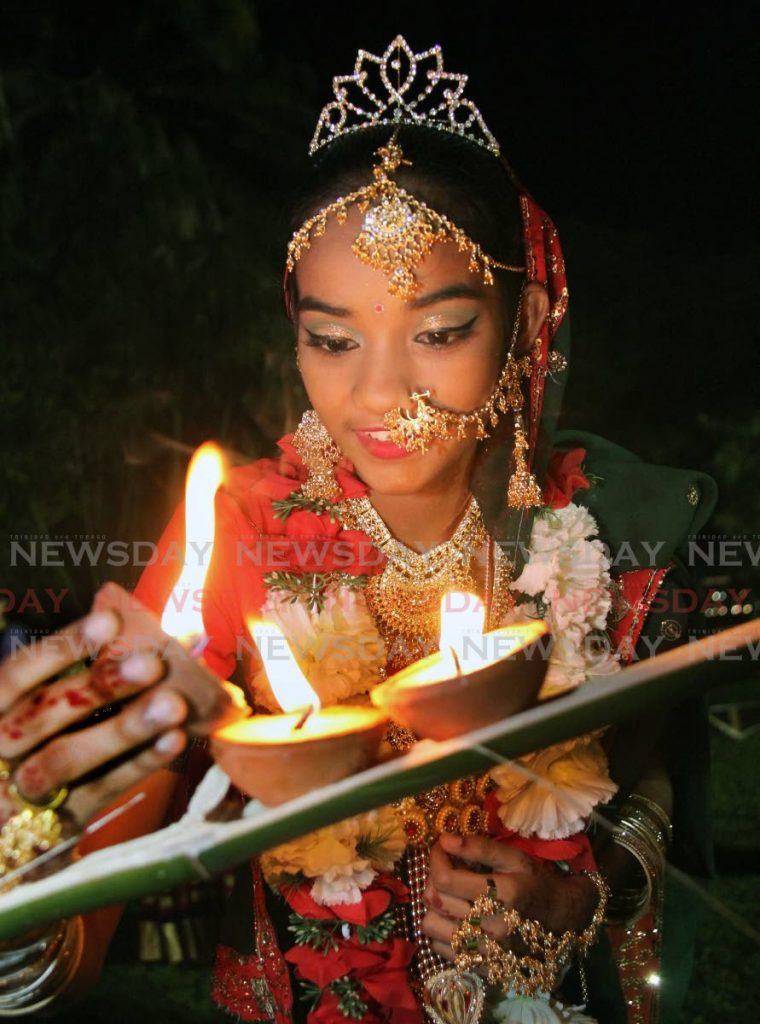 FILE PHOTO: Rohini Mangru of St Johns Trace Siparia lights deyas at the band stand of the Royal Botanic Gardens, St Ann's, Port of Spain at Divali celebrations hosted by the Office of the President on October 14, 2017. Photo by Sureash Cholai