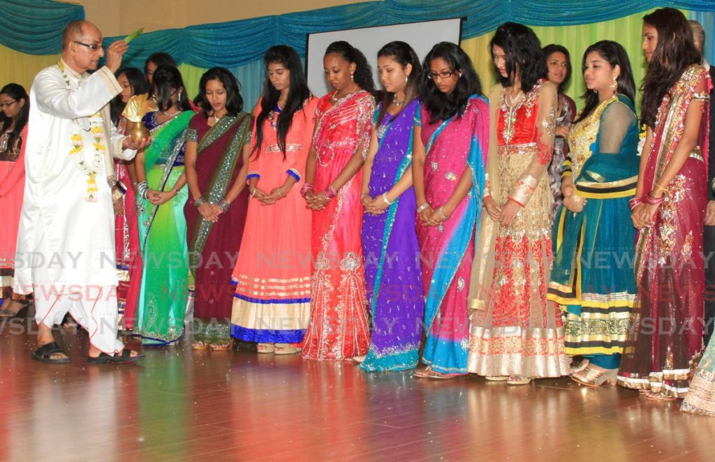 In this October 30, 2015 file photo Pundit Uttam Maharaj blesses the 27 scholarship winners from Lakshmi Girls' Hindu College. The Maha Sabha says Government's cut of scholarships from 400 to 100 will make it harder for secondary school students to access tertiary education. - ROGER JACOB
