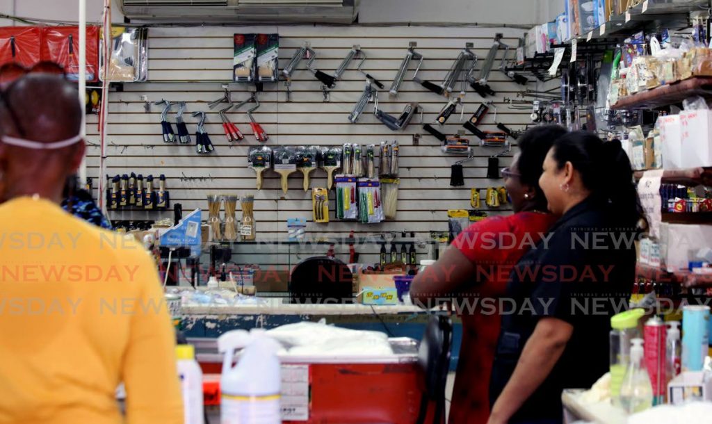 Customers waiting in line at a hardware store in Port of Spain. Photo by Sureash Cholai- 