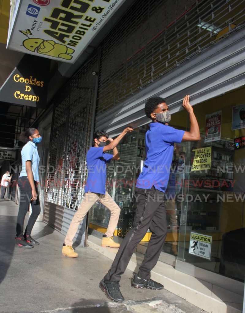 Employees open a store to start the day’s business in Port of Spain. Small and medium enterprises will have to find new ways to grow even during the pandemic, Flow SME sales manager Denisha Hamilton-Bailey advises. PHOTO BY ANGELO MARCELLE - 