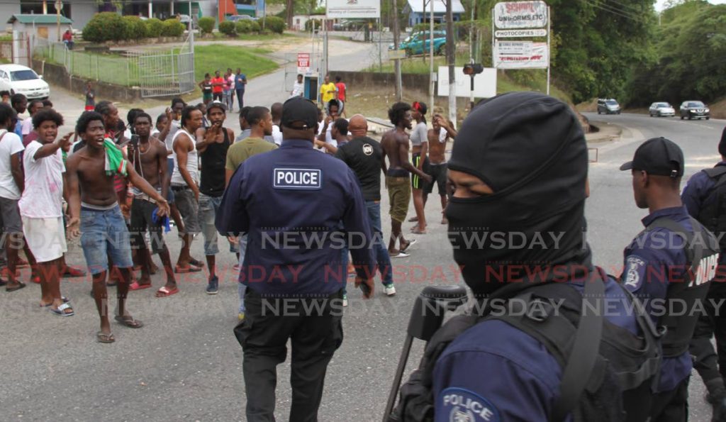 In this June 30, 2020 file photo, police control a crowd of youths protesting in Morvant. Opposition MP Khadijah Ameen on Friday said Government is neglecting young people in at-risk communities. - 