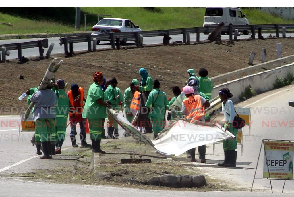 In this July 2020 photo, a group of CEPEP workers clean the roadway near the flyover in east Port of Spain. - Sureash Cholai