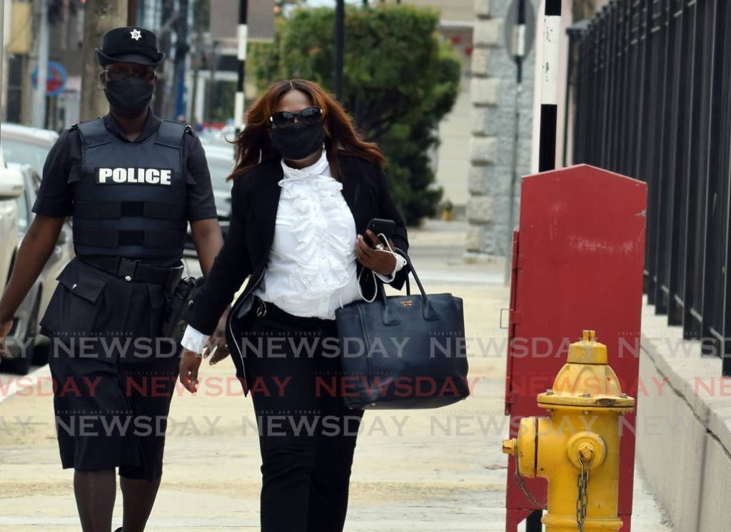 Opposition Senator Jearlean John is escorted by police to the Red House on August 29. - Photo by Vidya Thurab