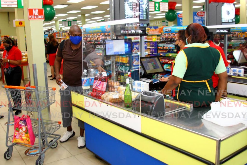 In this Ocotber 23, 2020 file photo shoppers cash for their groceries at Diskomart Supermarket in San Juan. Supermarkets and food store retailers will open for 24 hours for Christmas. File photo/Roger Jacob - 