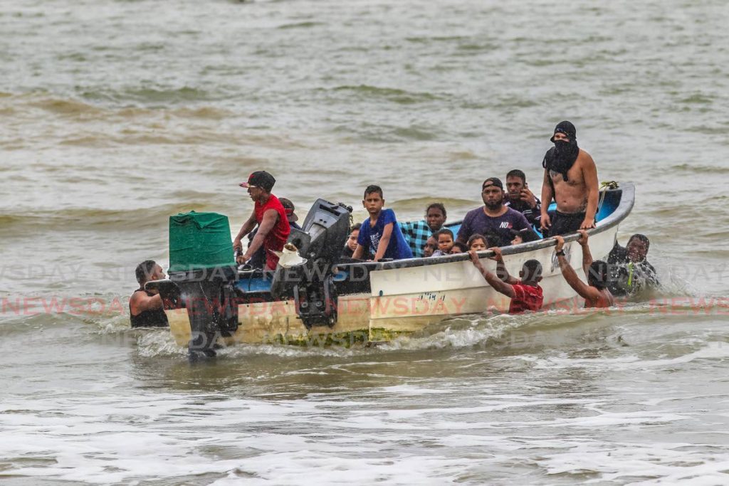 In this November 11, 2020 file photo, Venezuelan migrants arrive illegally at Los Iros beach, Erin. FILE PHOTO/LINCOLN HOLDER - 