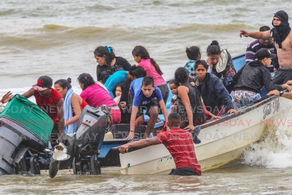 Venezuelans, including 16 children, enter Trinidad and Tobago illegally on board a pirogue at Los Iros beach. - Lincoln Holder