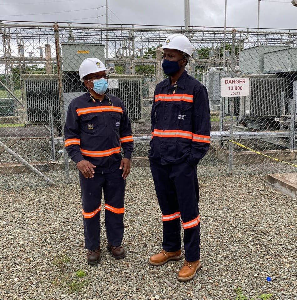 Chief Secretary Ancil Dennis, right, on a visit last week to Cove Power Plant. PHOTO COURTESY THA  - 