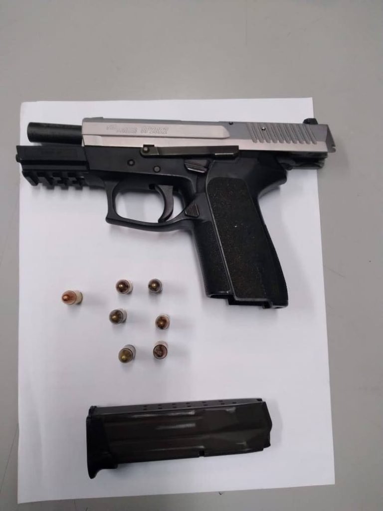 A Sig Sauer pistol and seven rounds of ammunition seized from a man in Wallerfield on Wednesday. 

PHOTO COURTESY TTPS - TTPS