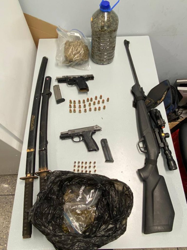 SEIZED: The two samurai swords at left, which were among items including firearms, ammunition and illegal drugs seized by police. PHOTO COURTESY TTPS - 