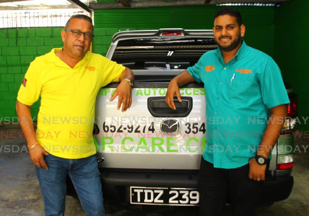 Businessman Vickram Sampath of V Sampath Auto Accessories and DGNL Co Ltd Car Care Centre and his nephew Deklon Mohan, operations manager at the company's new location on the corner of Scott Bushe and Charles Streets in Port of Spain. Photo: Roger Jacob - ROGER JACOB