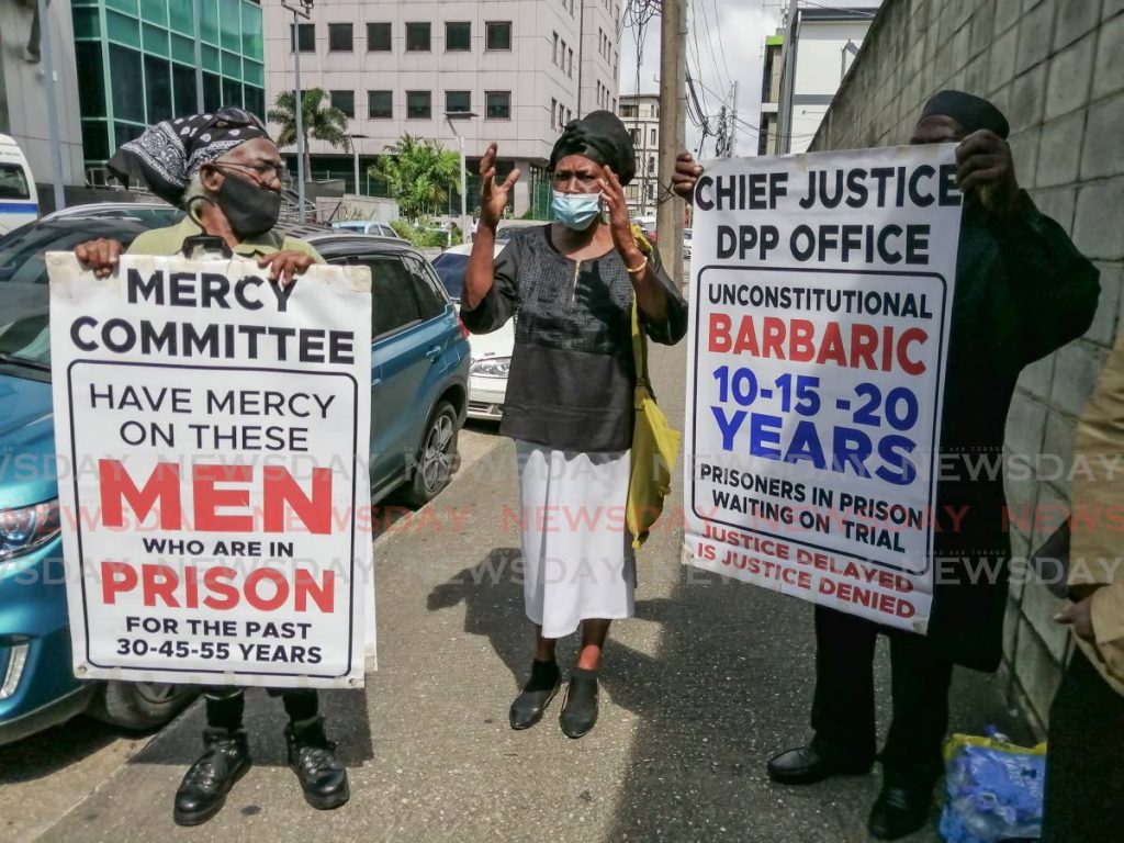 Ex-inmate Adrian Gokool, Stephanie Neptune, whose son is awaiting trial for murder for the past 12 years, and activist Salim Muwakil outside the Office of the Attorney General, Richmond Street, Port of Spain on Friday seeking to raise awareness about urgent reform of the criminal justice system. - Darren Bahaw