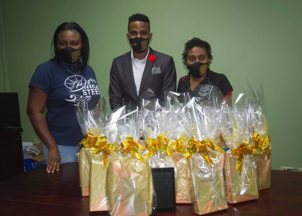 RONDELLE KELLER (centre) presents tablets to teachers Aril Goodman (left) and Jonquille Blades (right.) - 