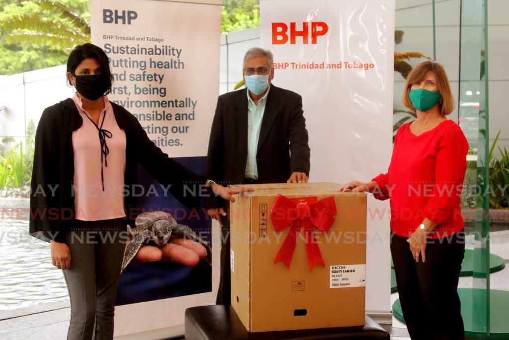 BHP Billiton TT in association with Arrive Alive donated a printer to Pepper Village Government School, Fyzabad.  From left, principal Krisenbdaye Ramai receiving from BHP corporate affairs manager Sheldon Narine and  Arrive Alive chairman Sharon Inglefield, at the Atrium,Invaders Bay Towers, Audrey Jeffers Highway, Port of Spain. - Sureash Cholai