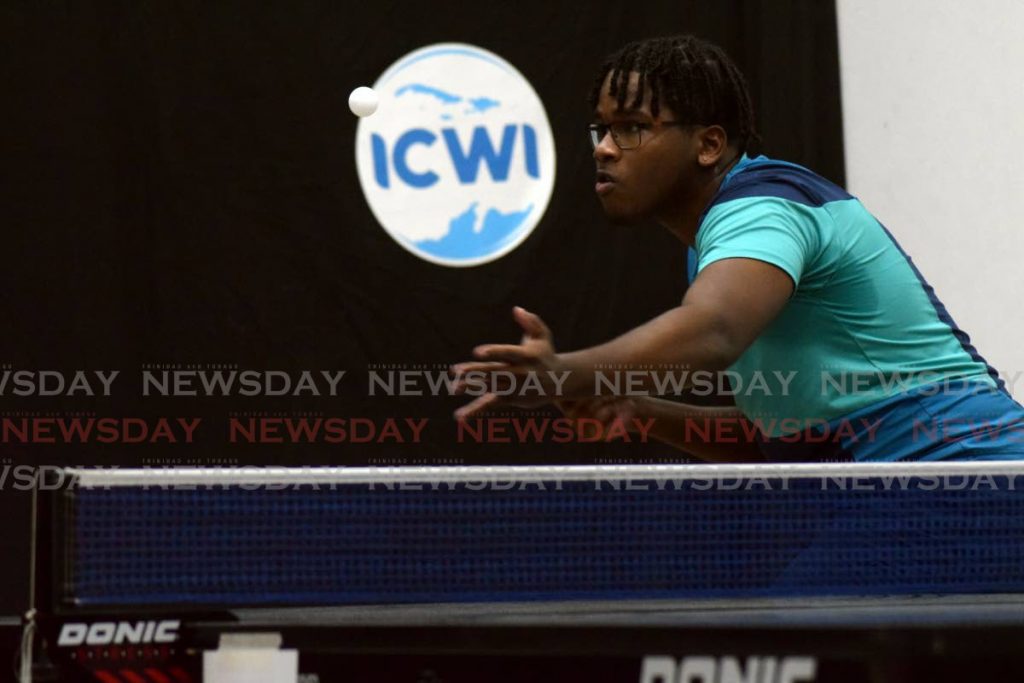 Josiah Cottoy plays a shot in the Under-18 age group of the Queen's Park Junior Table Tennis tournament at the Queen's Park Racquet Centre in St Clair, on Saturday. Cottoy was eliminated in the early stages of the knockout phase.  - Vidya Thurab