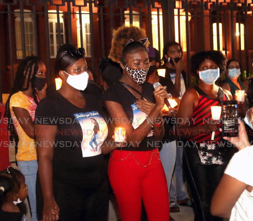 File photo: Namyamla Wellington, centre, sings for her murdered sister Ashanti Riley during a candlelight vigil outside the Red House after a motorcade from the family home on Lloyd Street, San Juan to Port of Spain.
 
Photos by Angelo Marcelle 
