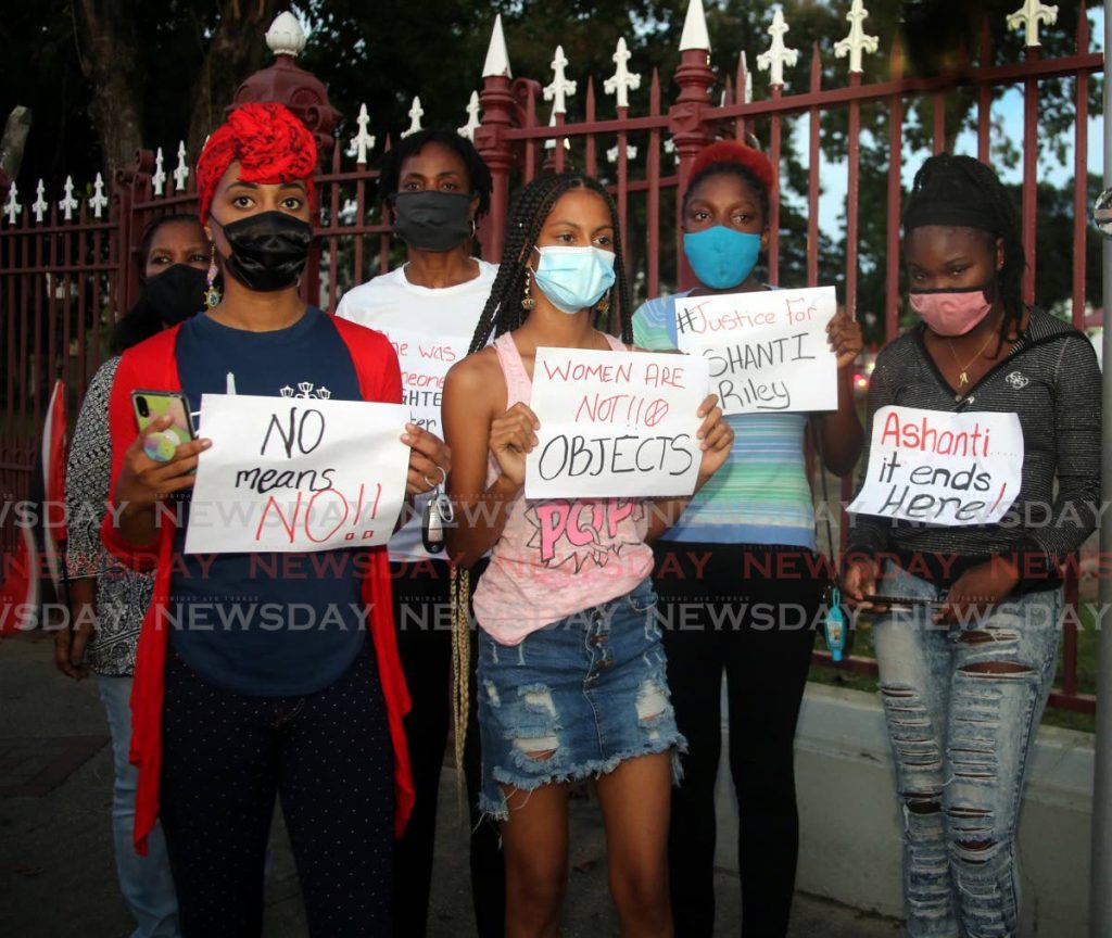 File photo: Protesters hold signs during a vigil outside Woodford Square, opposite the Red House, after a motocade from the family home in San Juan of murder victim Ashanti Riley to Port of Spain on Saturday. PHOTO BY SUREASH CHOLAI - 