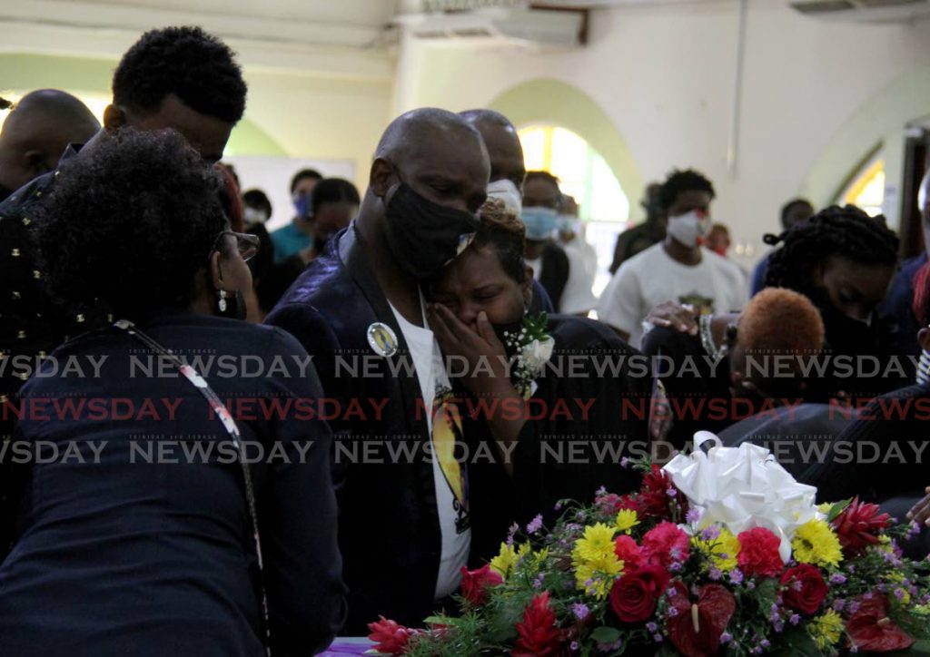Candice Riley, mother of Ashanti Riley is consoled by a relative during her funeral at the Mt D'or SDA Church on Monday.  - AYANNA KINSALE