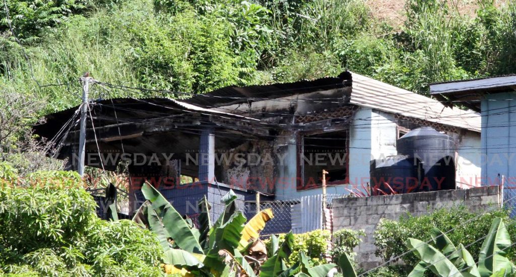 The fire-bombed Cocorite house of George Lewis 92 on Monday. Lewis died in the fire. - Angelo Marcelle