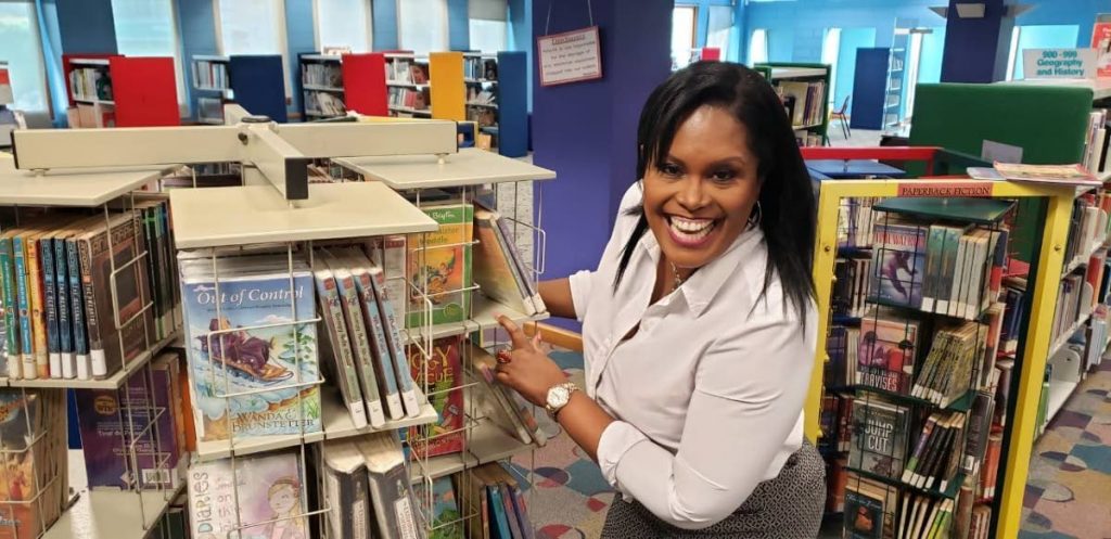 Media personality and CEO of Imagine Media International, Lisa Wickham peruses the book shelves at the Port of Spain Children’s Library. - 