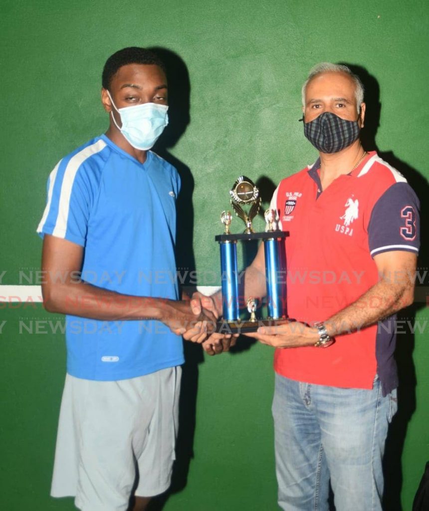 Men’s Singles winner Che Andrews, left, receives his trophy from 
Millennium Insurance Brokers’ Billy Ali.  - 