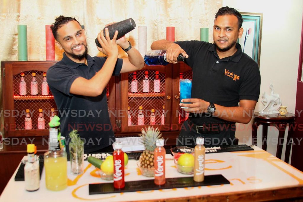 Brothers Neal and Clinton Ramdhan (left to right) share their mixology secrets as award-winning bartenders and owners of Verve Creations at Macoya Gardens, Macoya.  PHOTO BY ROGER JACOB - 