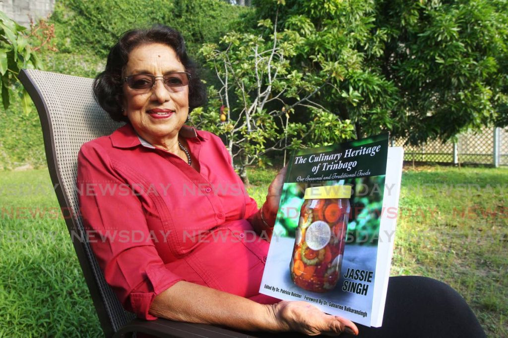 Jassie Singh holds a copy of her new book, at her home in Riverwoods, D'Abadie. PHOTO BY LINCOLN HOLDER - 