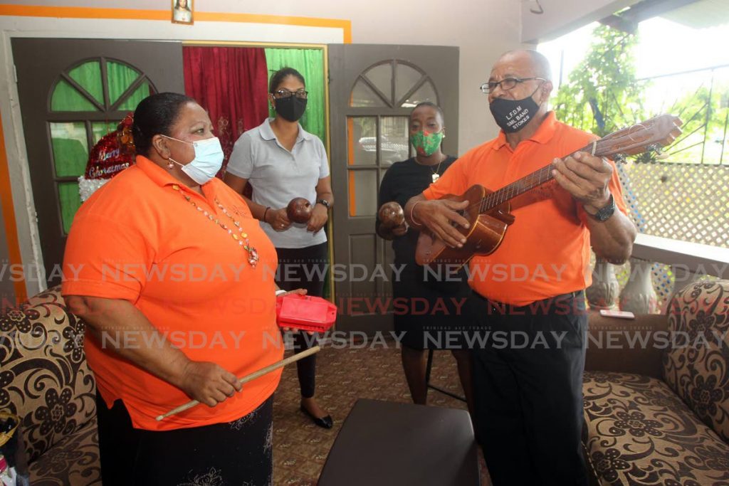 Manager of the parang group La Familia de Musica, Estulio Fraser, right, and his sister, left, at their home in Tabaquite. - Lincoln Holder