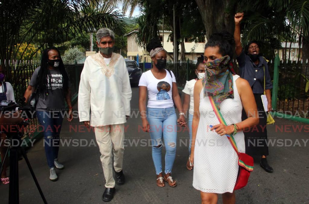 Wayne Kublalsingh, second from left, and Nazma Muller, second from right, leave the compound of the Office of the President after they delivered a letter to President Paula-Mae Weekes on Friday. - SUREASH CHOLAI