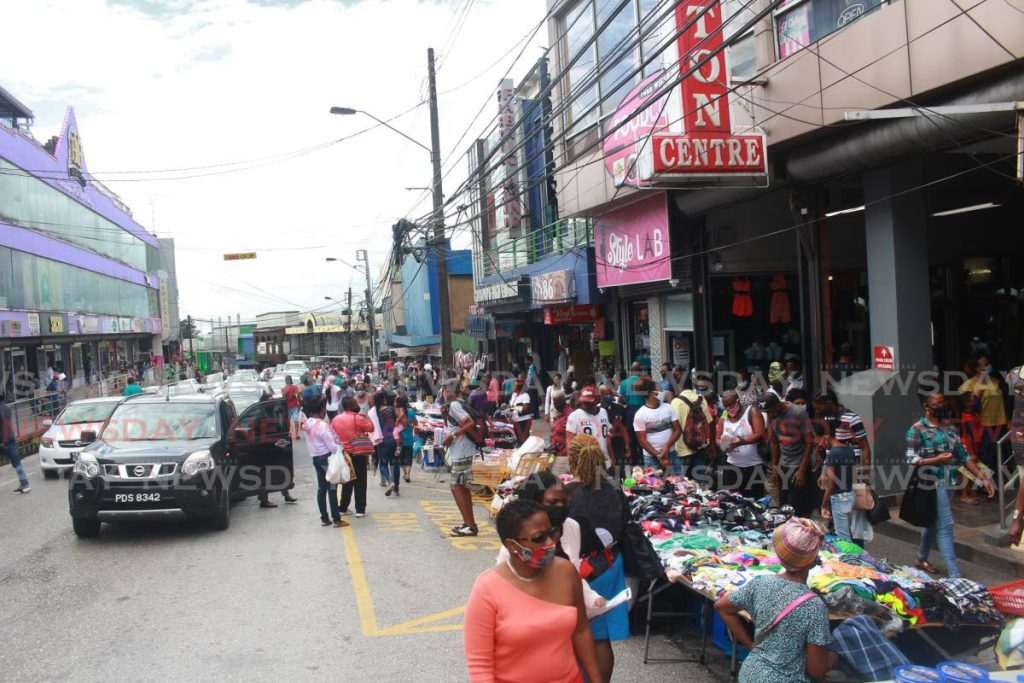 Scores of shoppers flood High Street, San Fernando, looking for Christmas items on Friday afternoon. - CHEQUANA WHEELER