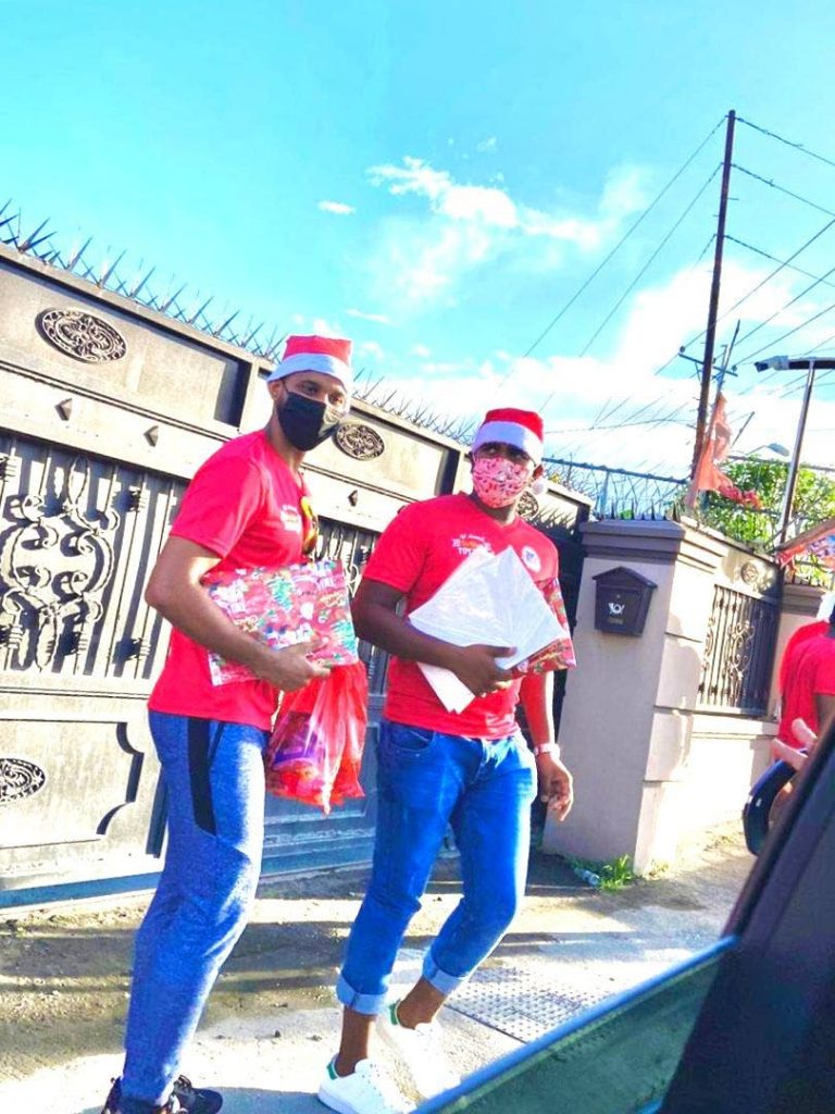 Secretary of Endeavour Cricket Club Clinton Williams, left, and club president Andy Gobin on the move during the club's toy drive, on Sunday. - 