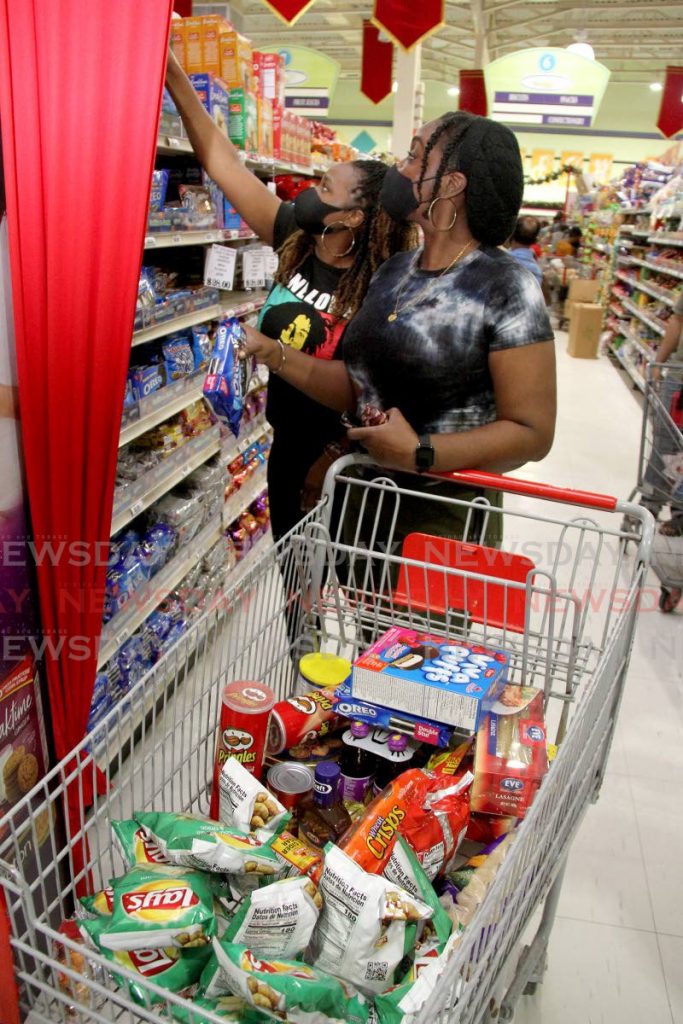 Customers shop at a grocery in east Trinidad. Photo by Angelo Marcelle