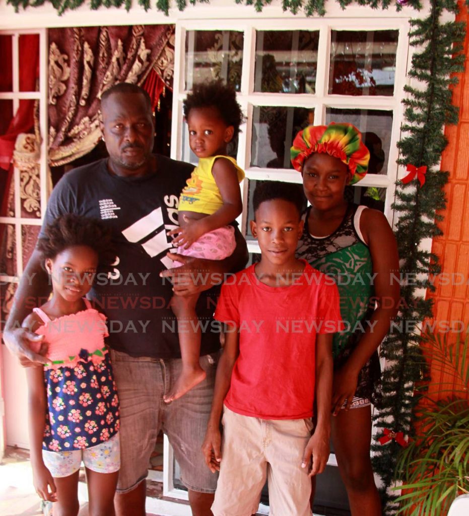 Darren Joseph, husband of Ornella Greaves, with their children Gabriella, 14; Jeremiah ten; Angel, seven; and Mariah, two at their Fourth Street, Beetham Gardens home - ROGER JACOB