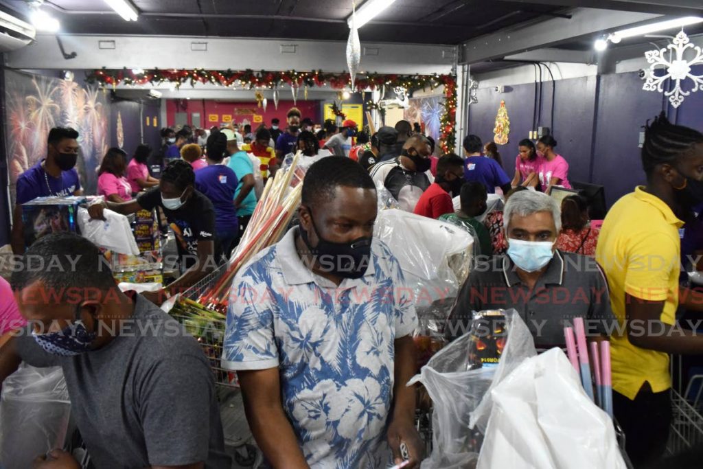 Customers crowd the checkout lines after buying stocks at FireOne Fireworks, Macoya in the Boxing Day sale on Saturday. PHOTO BY VIDYA THURAB - 