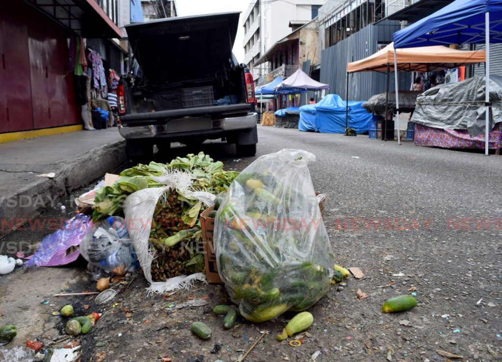 MORE MESS: Discarded vegetables, cardboard boxes, plastic bottles and containers litter the drain on Charlotte street, Port of Spain, even as very little vending took place in the city on Sunday. - Vidya Thurab