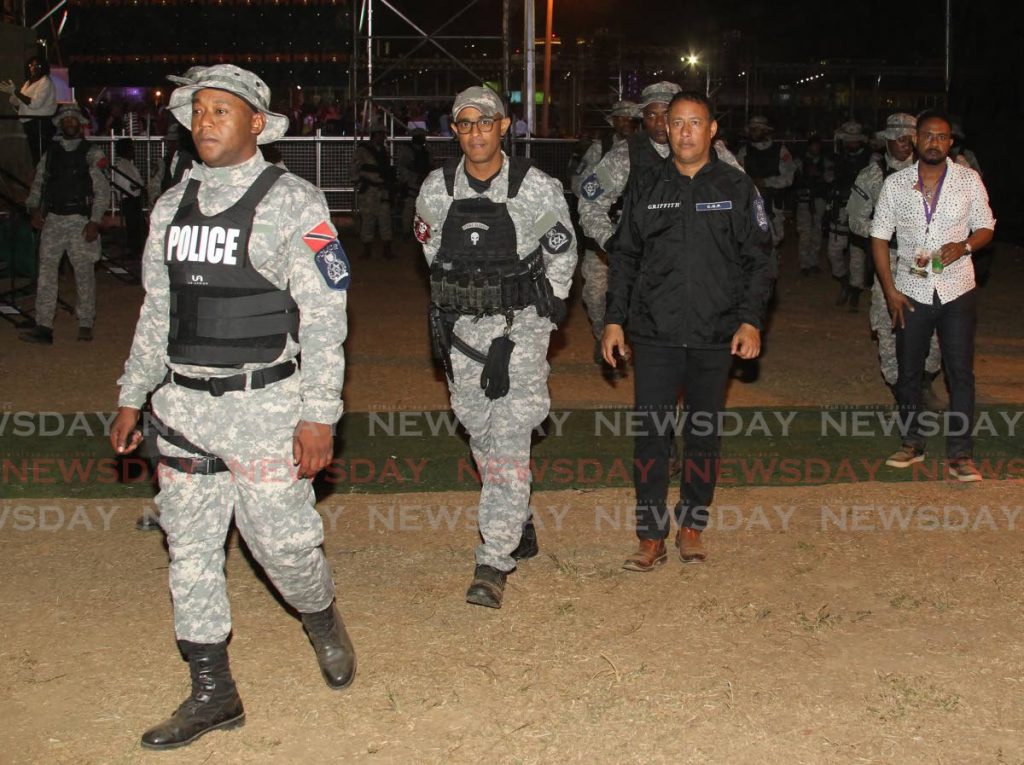 File photo: Sgt Mark Hernandez, left, accompanies Police Commissioner Gary Griffith, to the Buju Banton concert at the Queen's Park Savannah, in 2019. - ROGER JACOB
