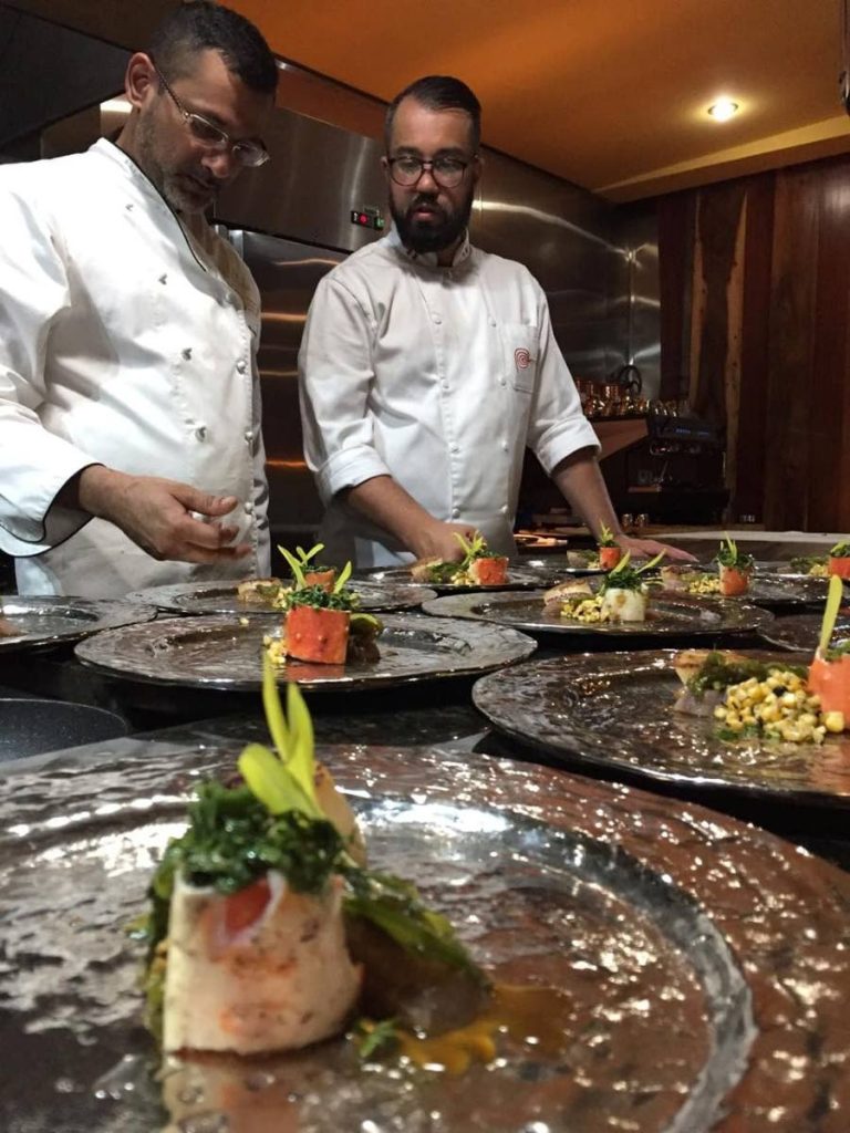 In this June 29, 2019 file photo, Peche Patisserie owner and chef Khalil Ali, left, and Peruvian chef Guillermo Russo prepare dishes for the Chefs Table, Chaguanas. - 