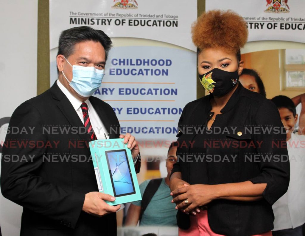 In this file photo, NGC Ltd President, Mark Loquan, presents Minister of Education, Dr. Nyan Gadsby-Dolly with one of several devices donated to the ministry at the Ministry of Education Head Office, Port of Spain. - Angelo Marcelle