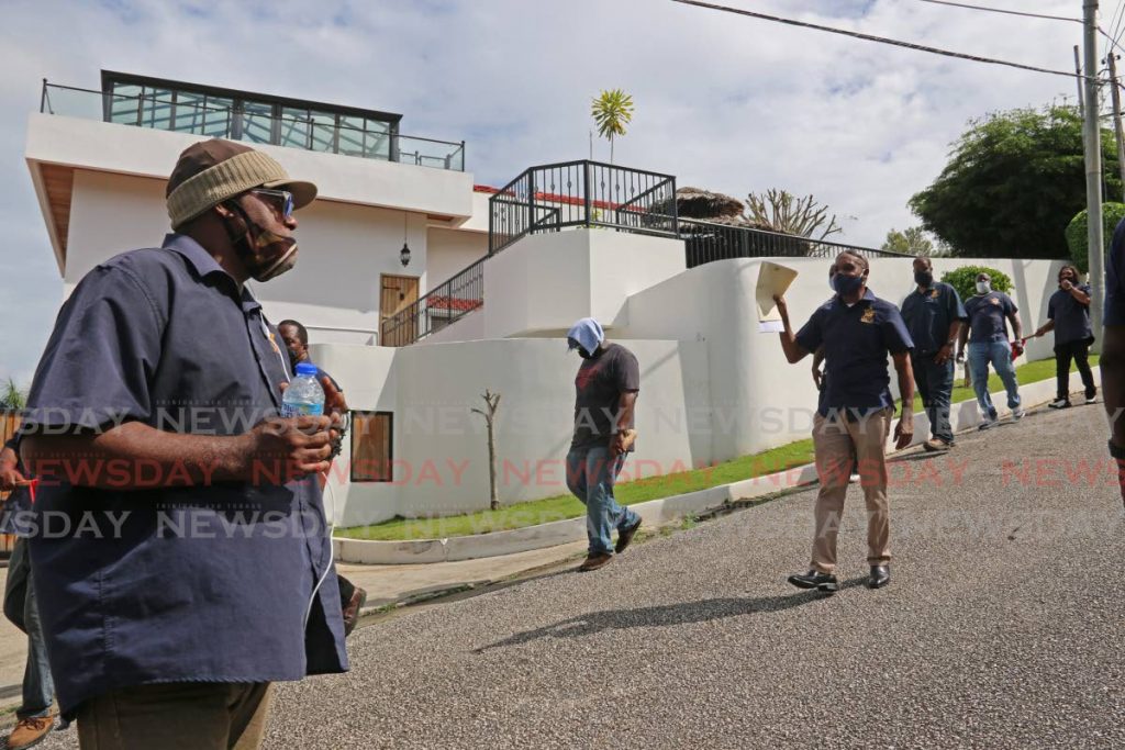 Ex-Lennox Petroleum workers, led by OWTU chief labour relations officer Lindon Mendoza, protest in front the home of the company's CEO Wayne Persad at Sumadh Gardens, Vistabella on Thursday last week.

On Thursday morning, OWTU chief labour relations officer, Lindon Mendoza and ex-Lennox petroleum workers held a silent protest in front of the home of Lennox Petroleum CEO's residence, Wayne Persad, in Sumadh Gardens, Vistabella.
31/12/2020 - Marvin Hamilton