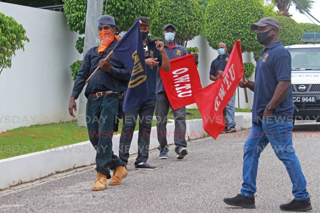 Ex-Lennox Petroleum workers protest outside the chief executive officer's house in Vistabella on Friday. - CHEQUANA WHEELER