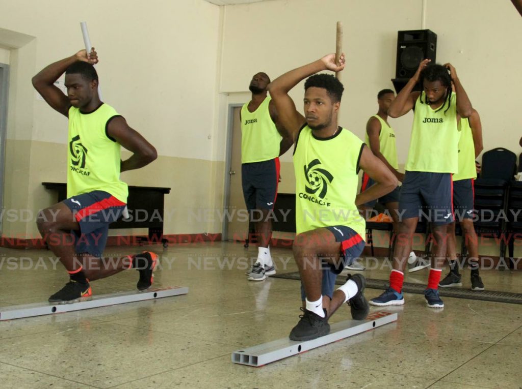 Members of the TT senior men’s football team take  part in a training exercise, on Sunday, at the St James Police Barracks. - AYANNA KINSALE