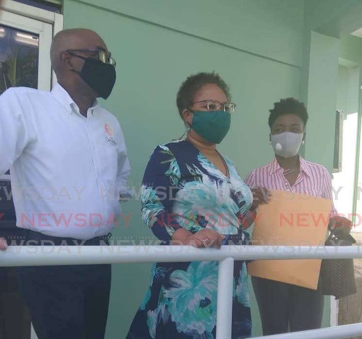 Dr Denise Tsoiafatt-Angus, centre, files her nomination papers at the former Tobago Correctional Facility, Montessori Drive, Glen Road, Scarborough, Monday. PHOTO BY COREY CONNELLY - 